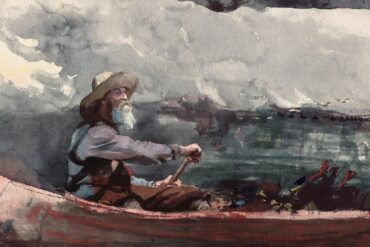 Man in canoe paddling through choppy water