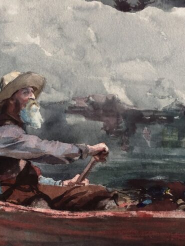 Man in canoe paddling through choppy water