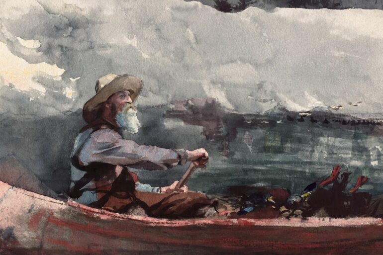 Man in canoe paddling through choppy water