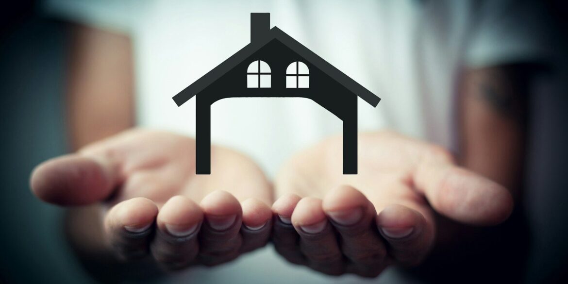 Hands holding a silhouette of a house