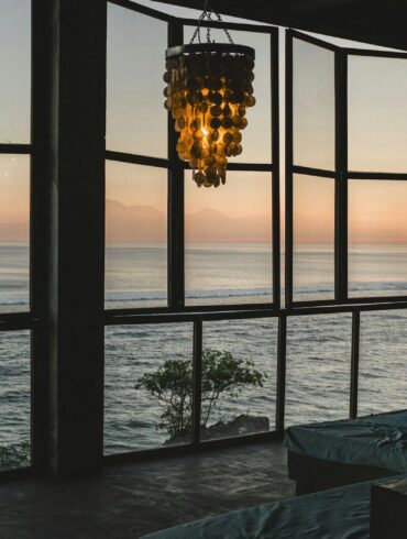 Modern room with ocean view at sunset