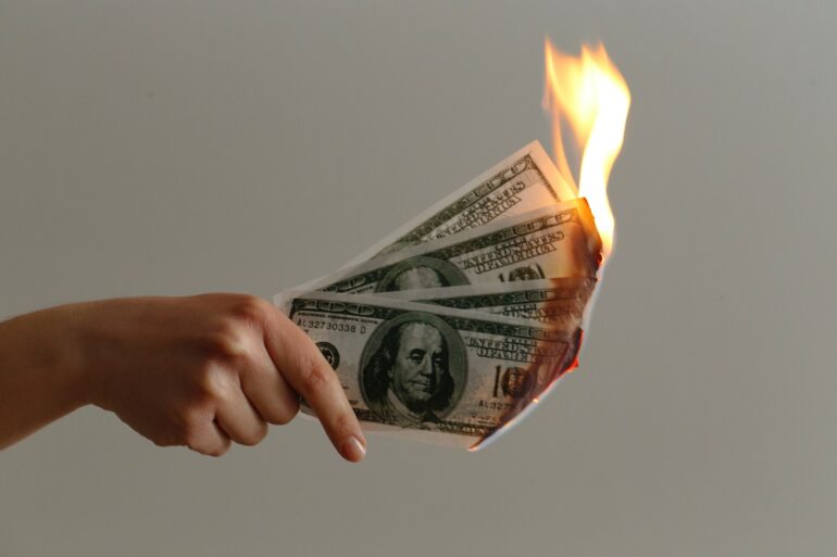 burned 100 US dollar banknotes