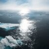 landscape and aerial photography of icebergs on body of water during daytime