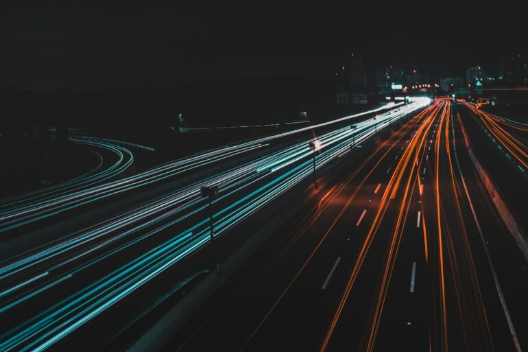 time lapse photography of lighted road at night