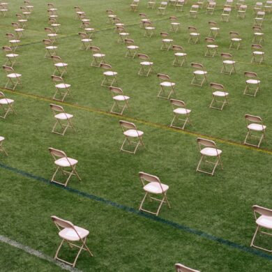 white folding chairs on green grass field