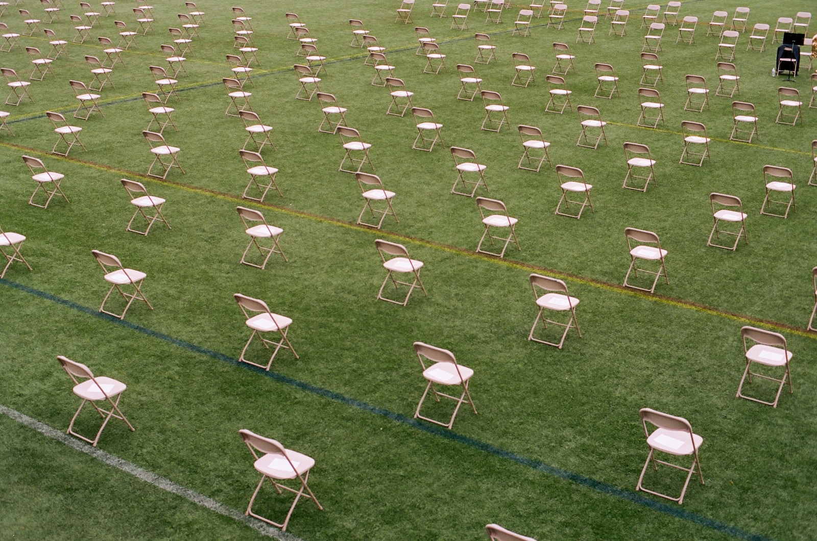 white folding chairs on green grass field