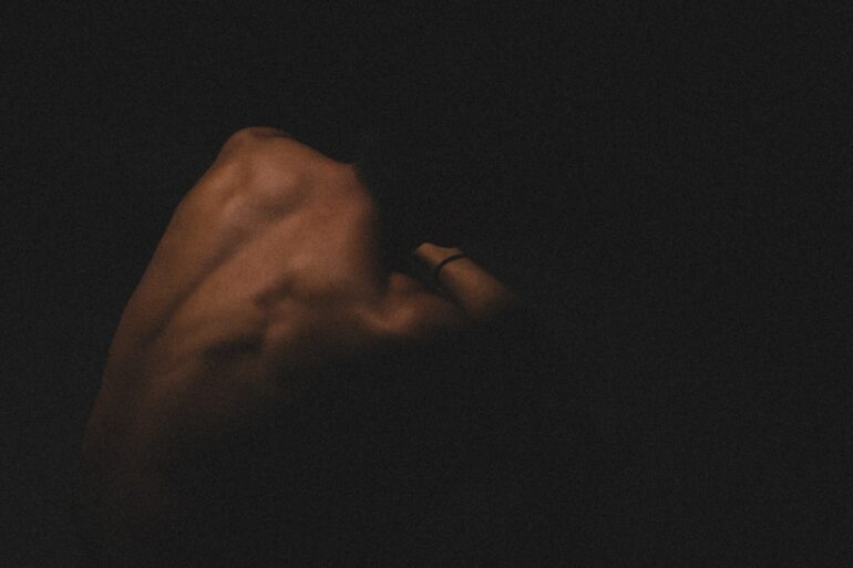 a hand holding a cell phone in the dark