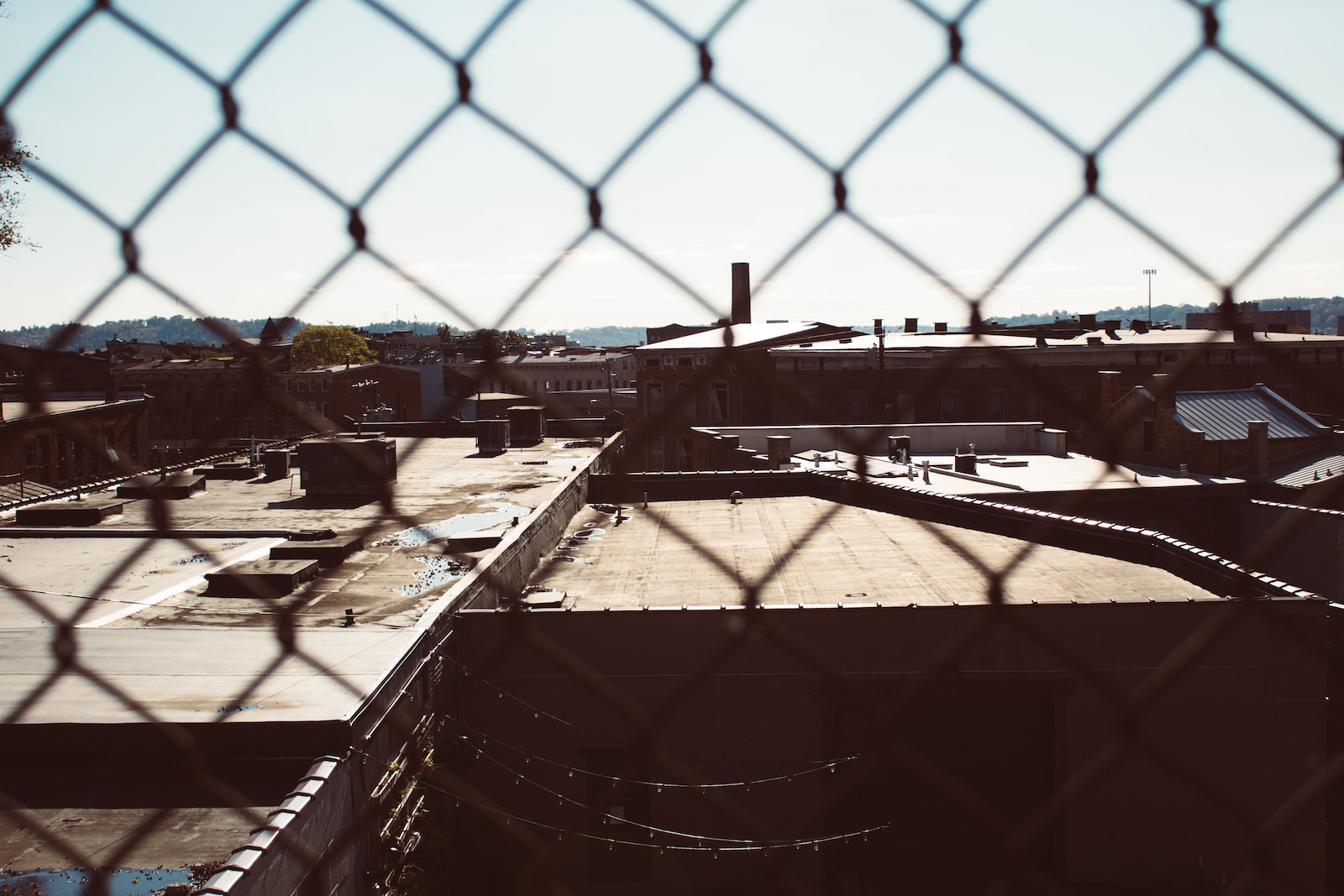 a view of a building through a chain link fence