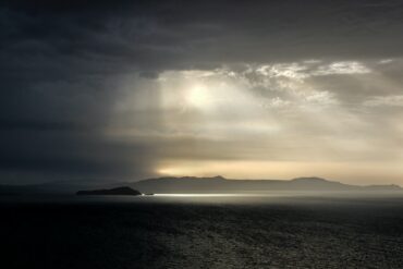 body of water under cloudy sky during daytime