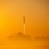 a rocket is flying through the air on a foggy day