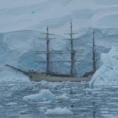 white galleon ship near glaciers