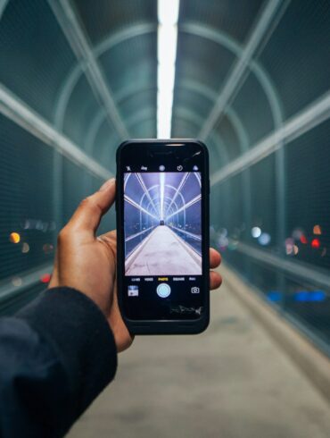 person holding phone showing empty tunnel