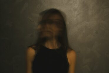a blurry photo of a woman in a black top