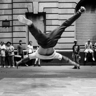 jumping man in grayscale photography